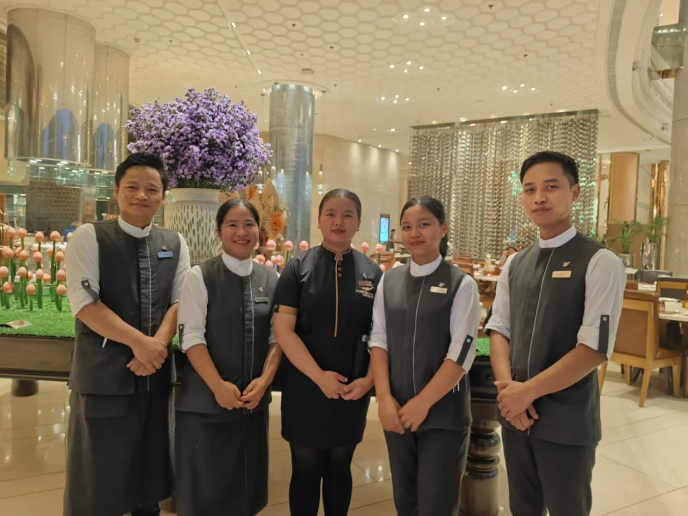 Student training at a luxury hotel front desk